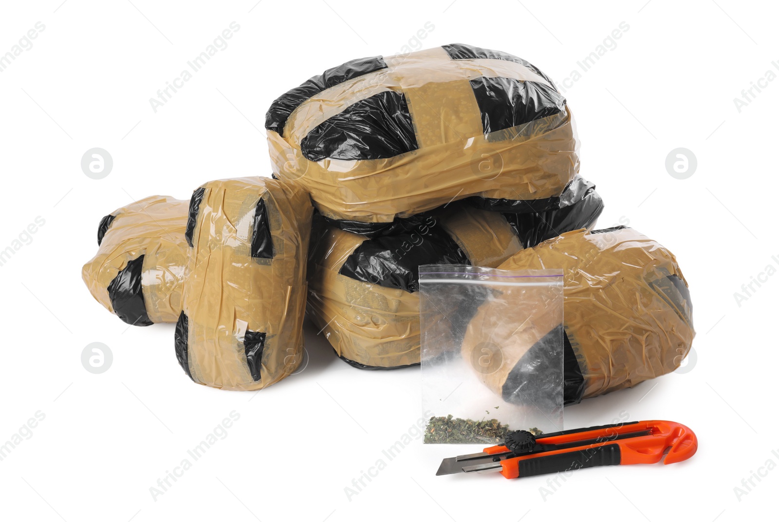 Photo of Packages with narcotics and stationery knife isolated on white