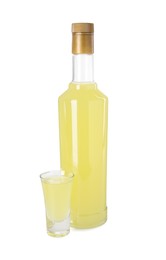 Bottle and shot glass with tasty limoncello liqueur isolated on white