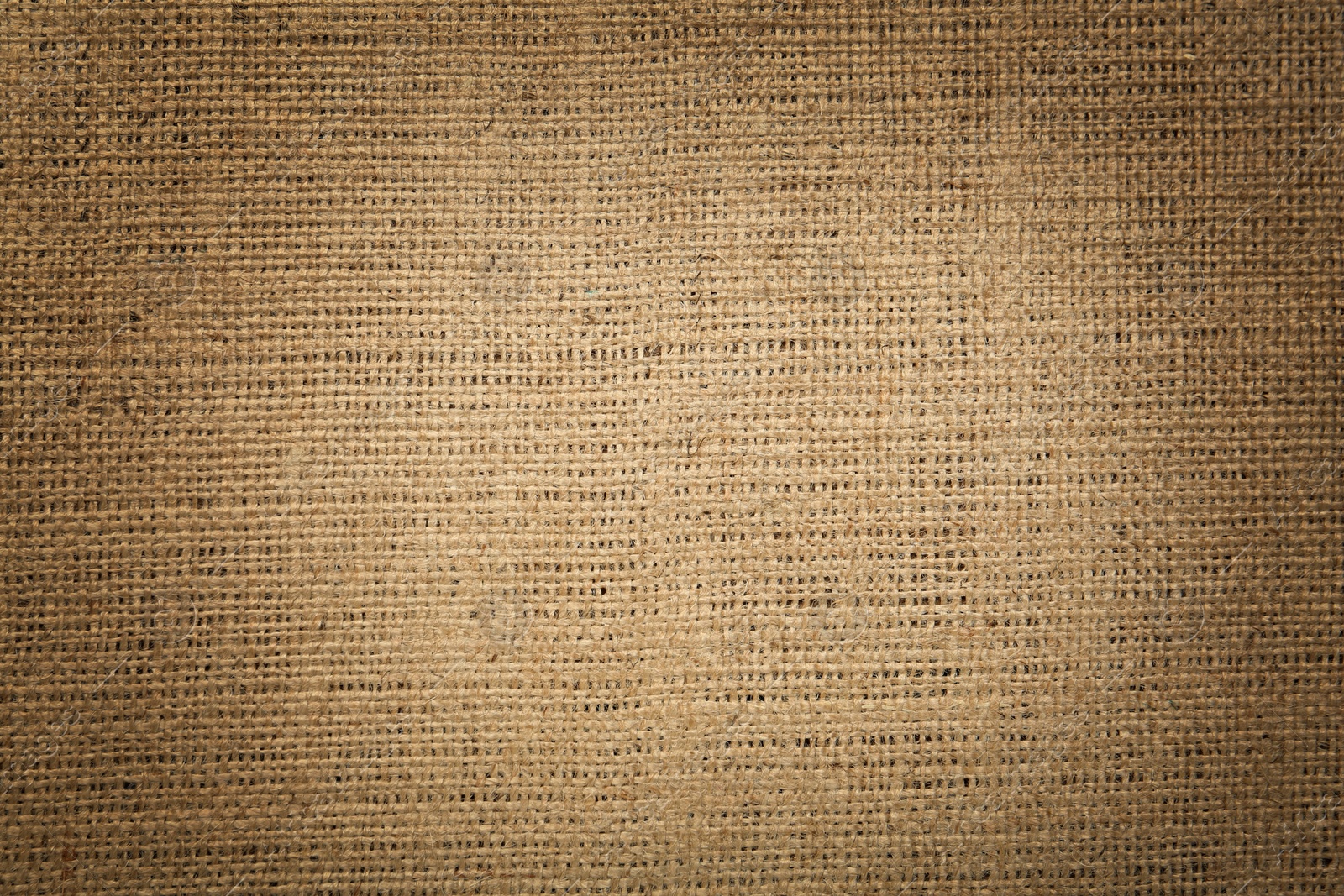 Image of Texture of natural burlap fabric as background, top view. Vignette effect 