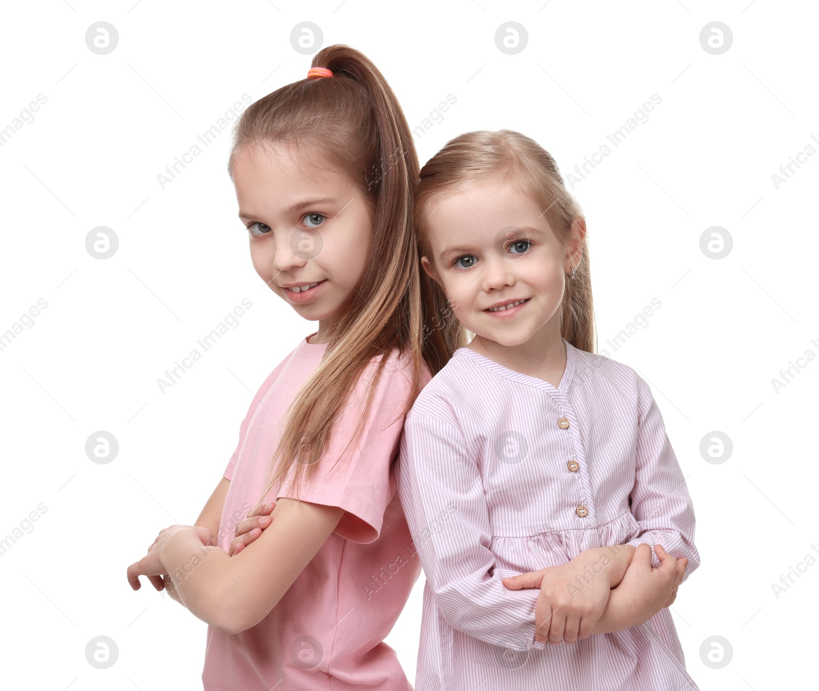 Photo of Portrait of cute little sisters on white background