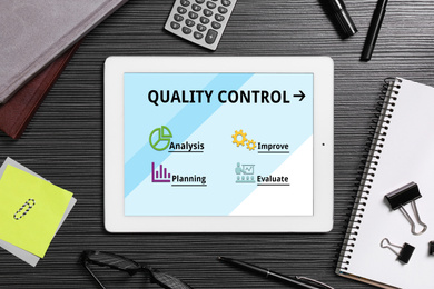 Image of Quality control service. Modern tablet on desk, flat lay