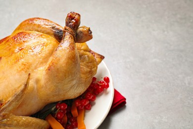 Photo of Delicious cooked turkey served on light table, closeup with space for text. Thanksgiving Day celebration