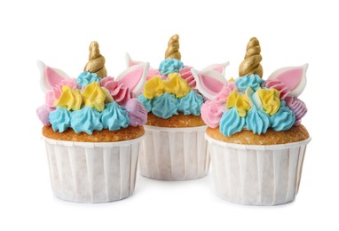 Photo of Three cute sweet unicorn cupcakes on white background