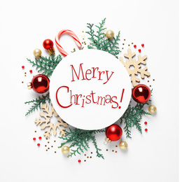 Image of Flat lay composition with text MERRY CHRISTMAS and festive decor on white background