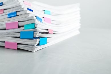 Photo of Stack of documents with binder clips on light table