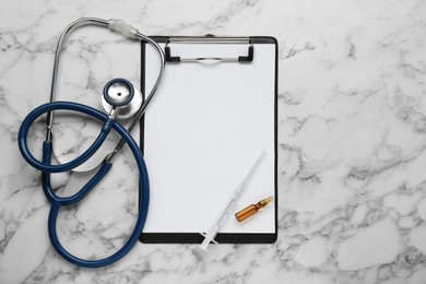 Clipboard with word Hepatitis, stethoscope, syringe and vial on white marble table, flat lay. Space for text