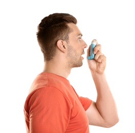 Photo of Young man with asthma using inhaler on white background