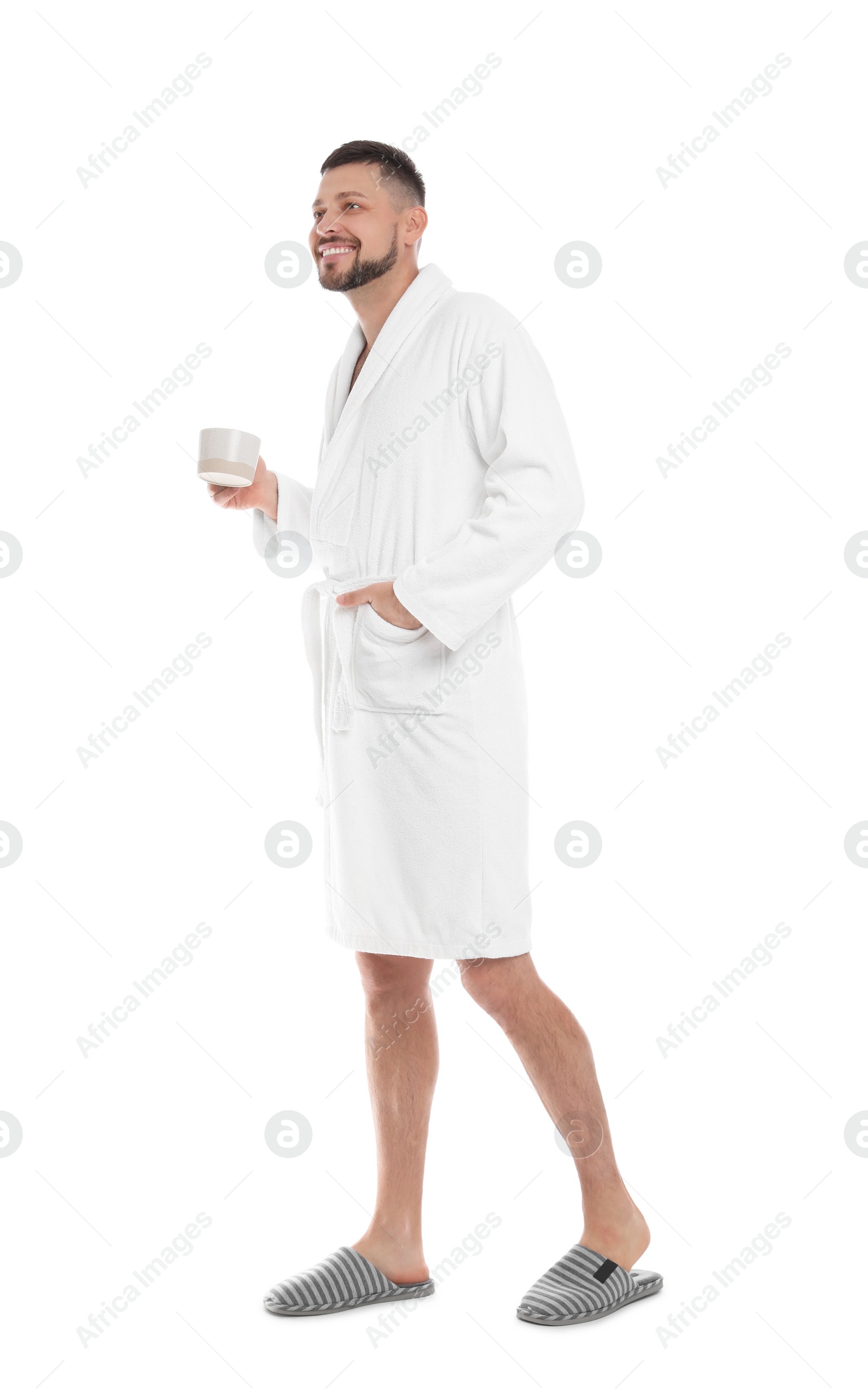 Photo of Handsome man in bathrobe with cup of coffee on white background