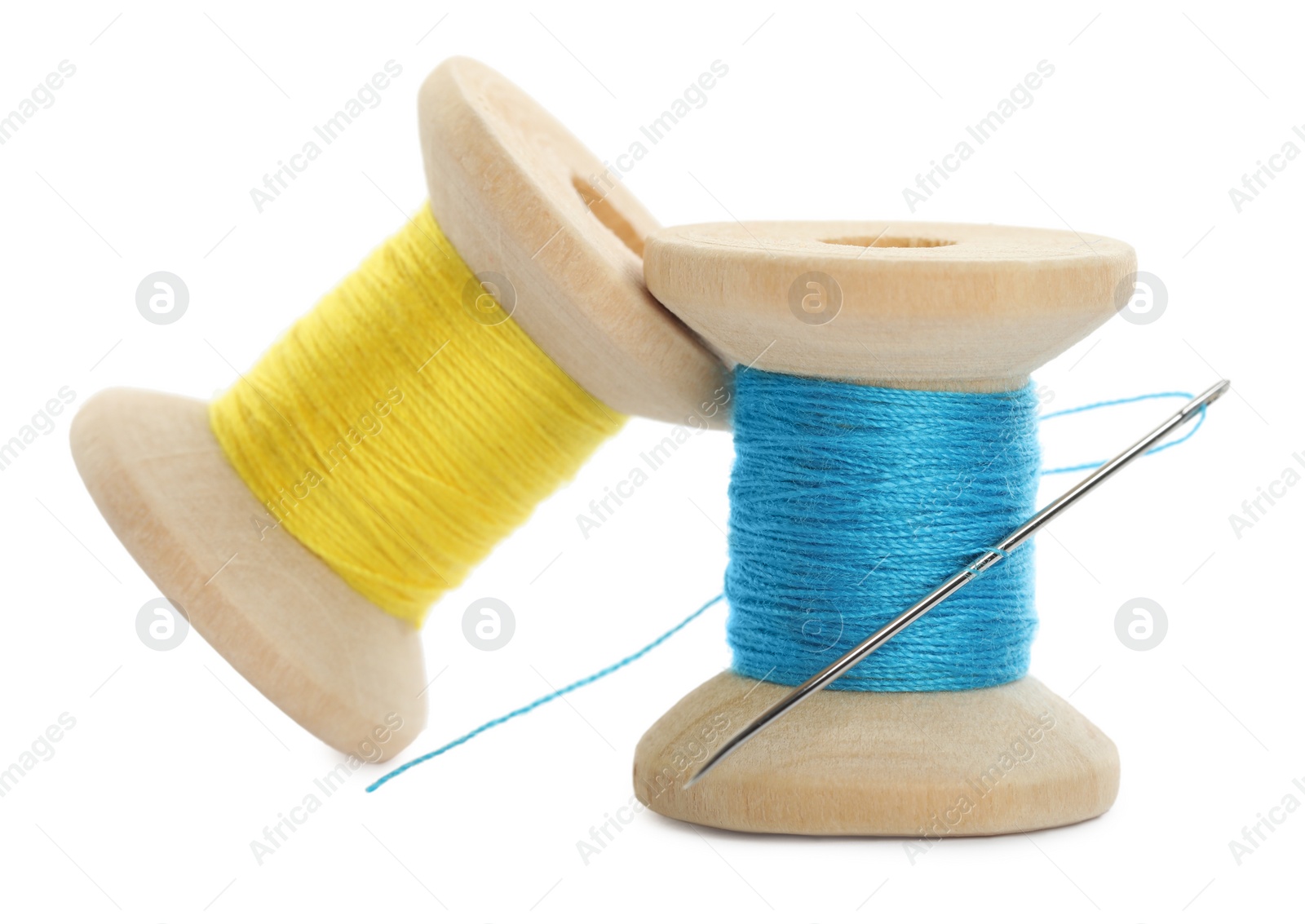 Photo of Colorful sewing threads with needle on white background, closeup