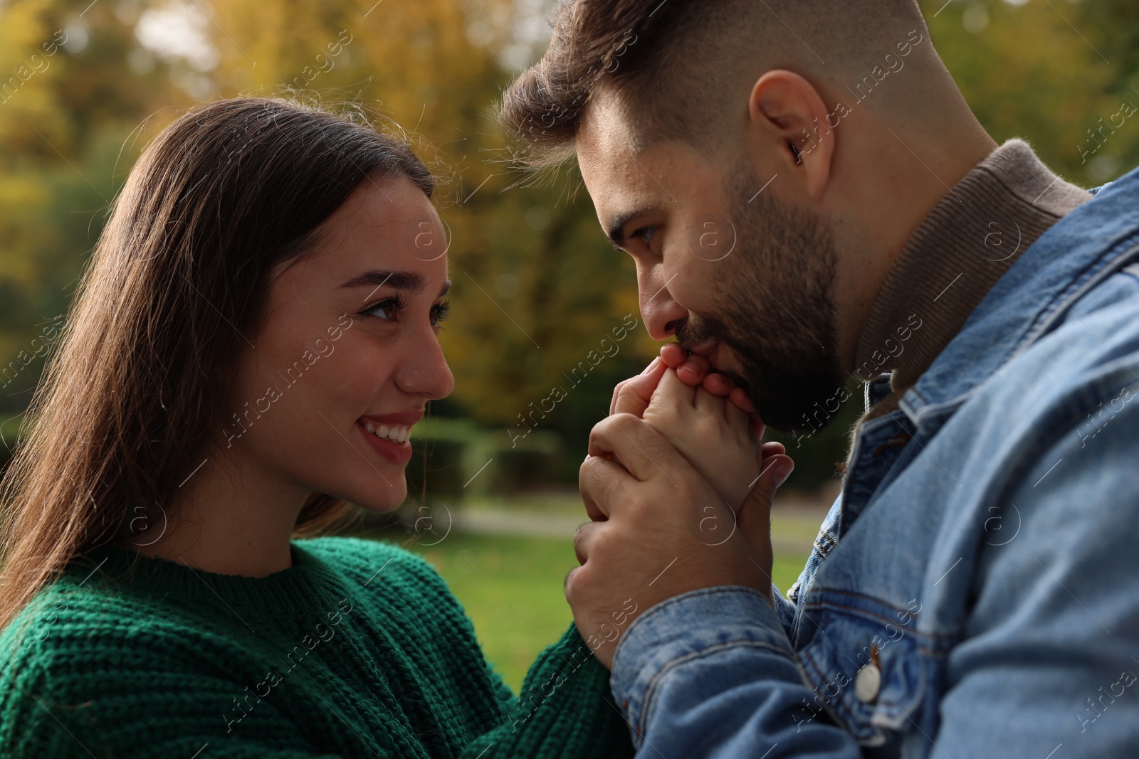 Photo of Happy young couple spending time together in autumn park