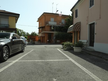 Beautiful street with parking lot and buildings on sunny day