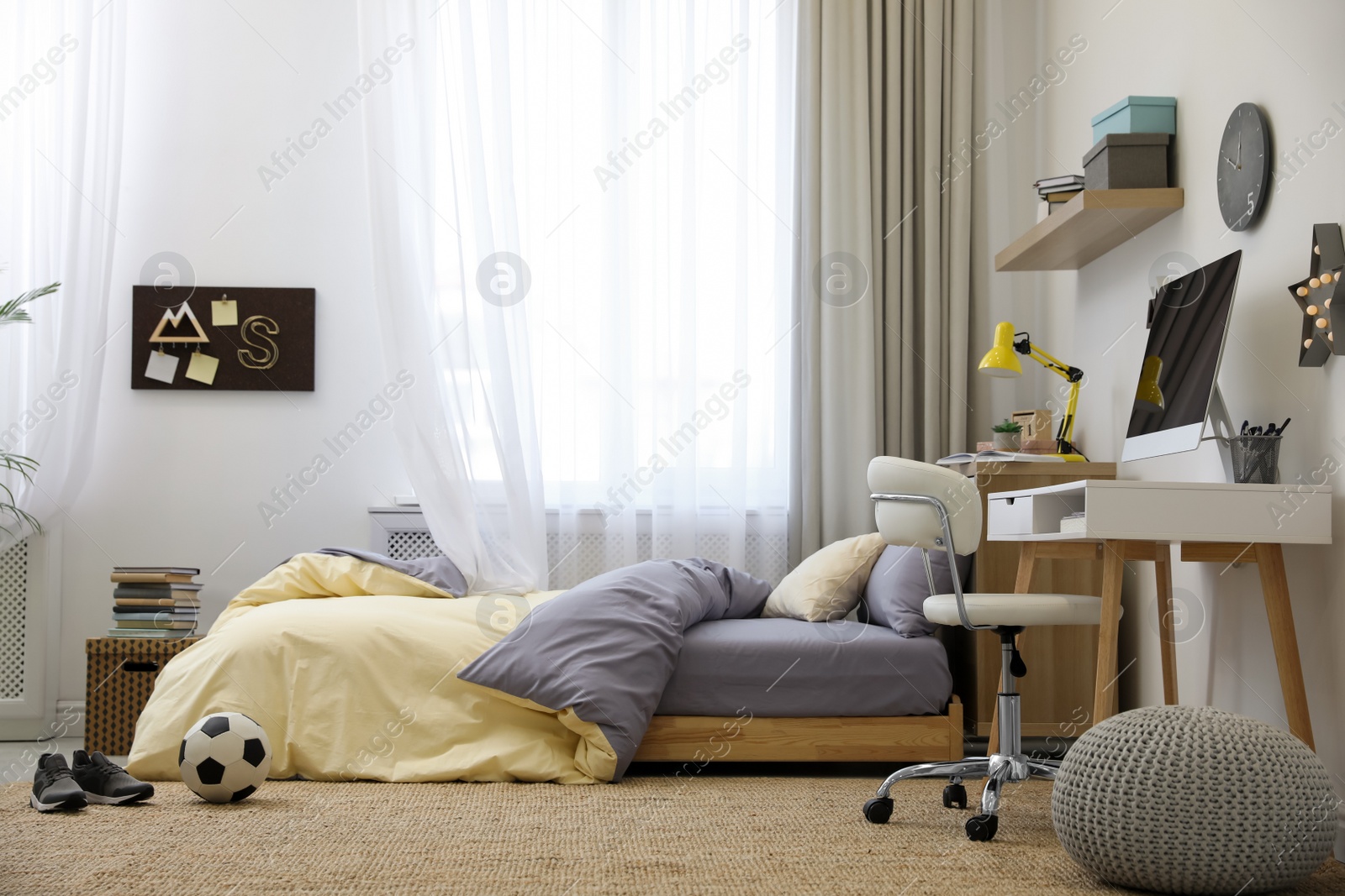 Photo of Stylish teenager's room interior with comfortable bed and workplace