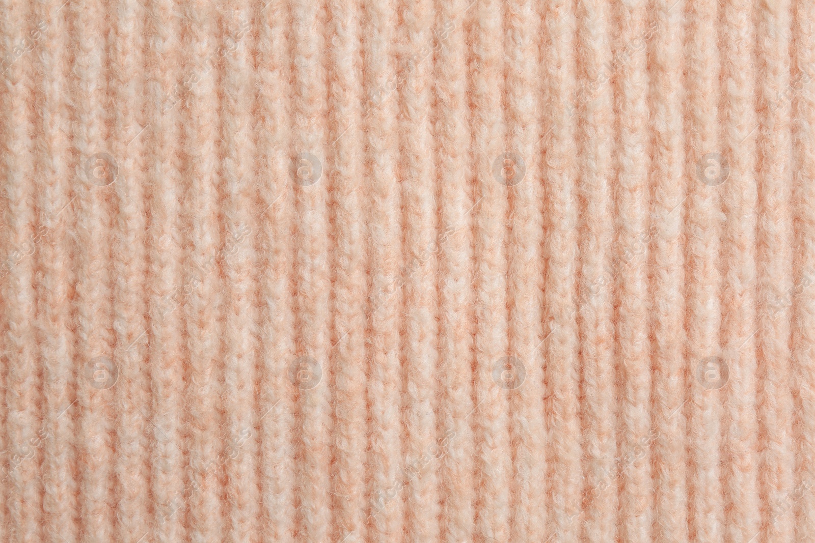 Photo of Beautiful pale pink knitted fabric as background, top view