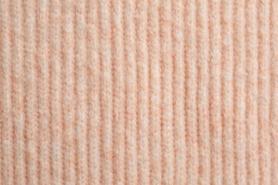 Photo of Beautiful pale pink knitted fabric as background, top view