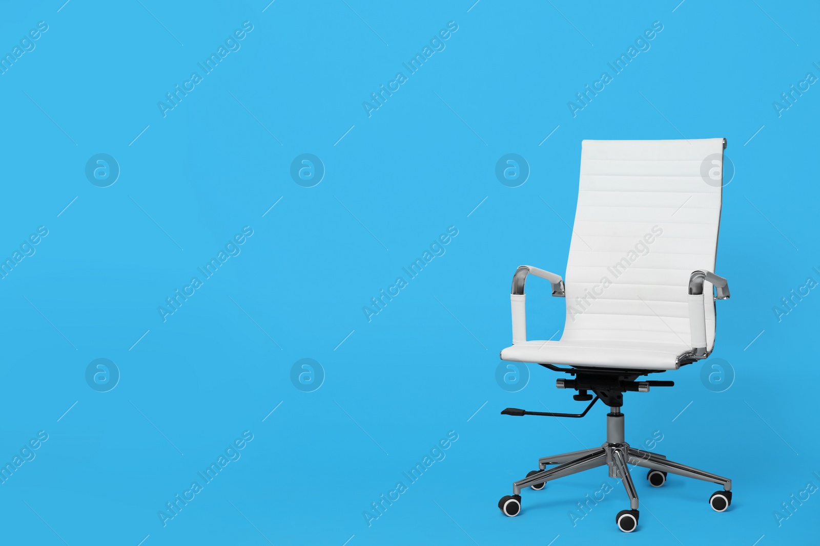 Photo of Comfortable office chair on light blue background, space for text