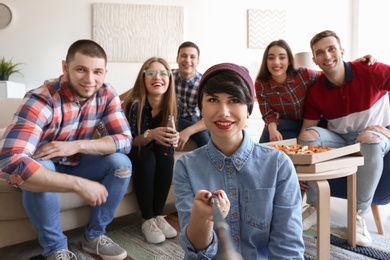 Photo of Happy friends taking selfie indoors