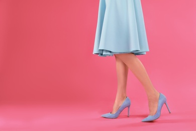 Photo of Woman in elegant shoes on pink background. Space for text