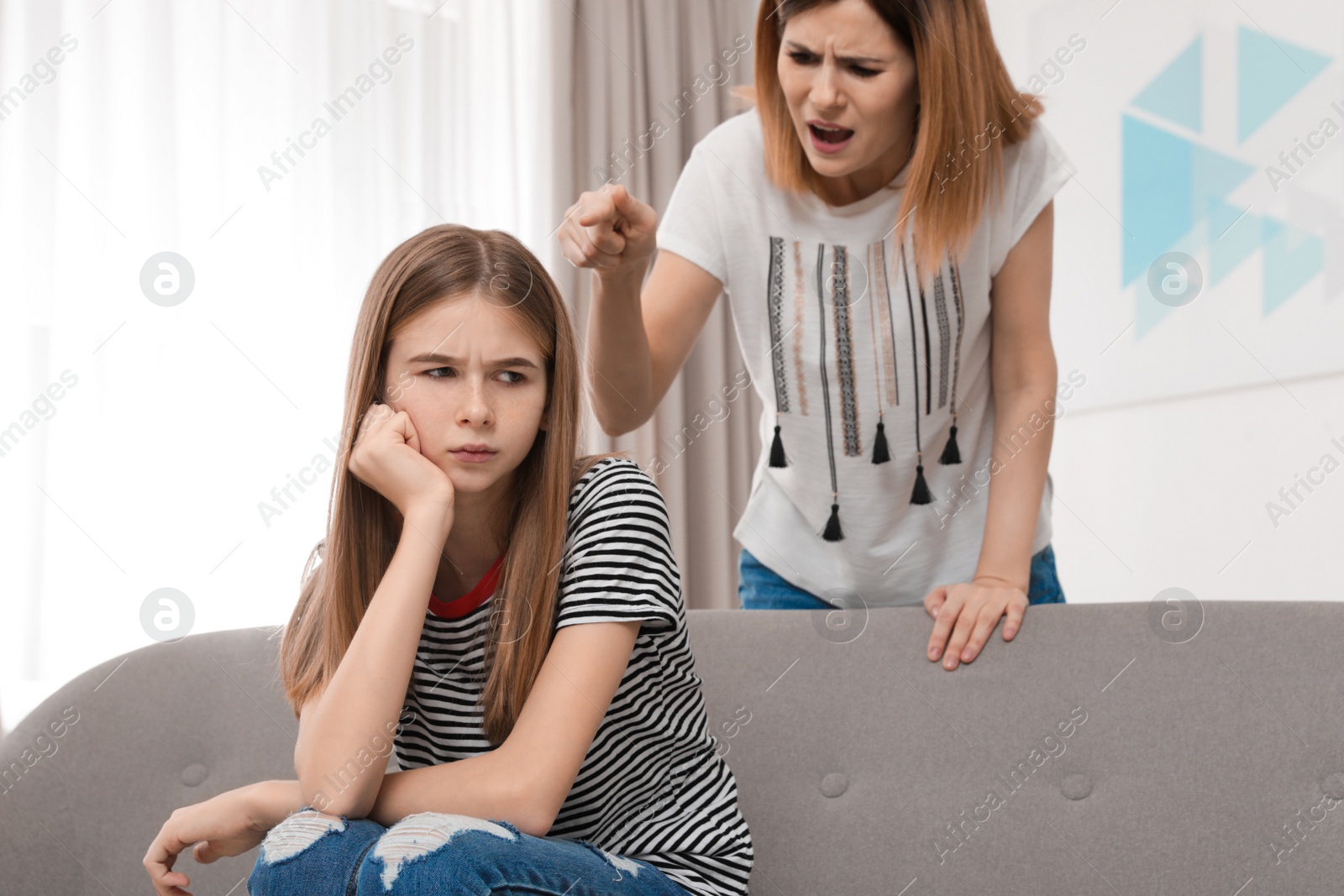 Photo of Mother scolding her teenager daughter at home