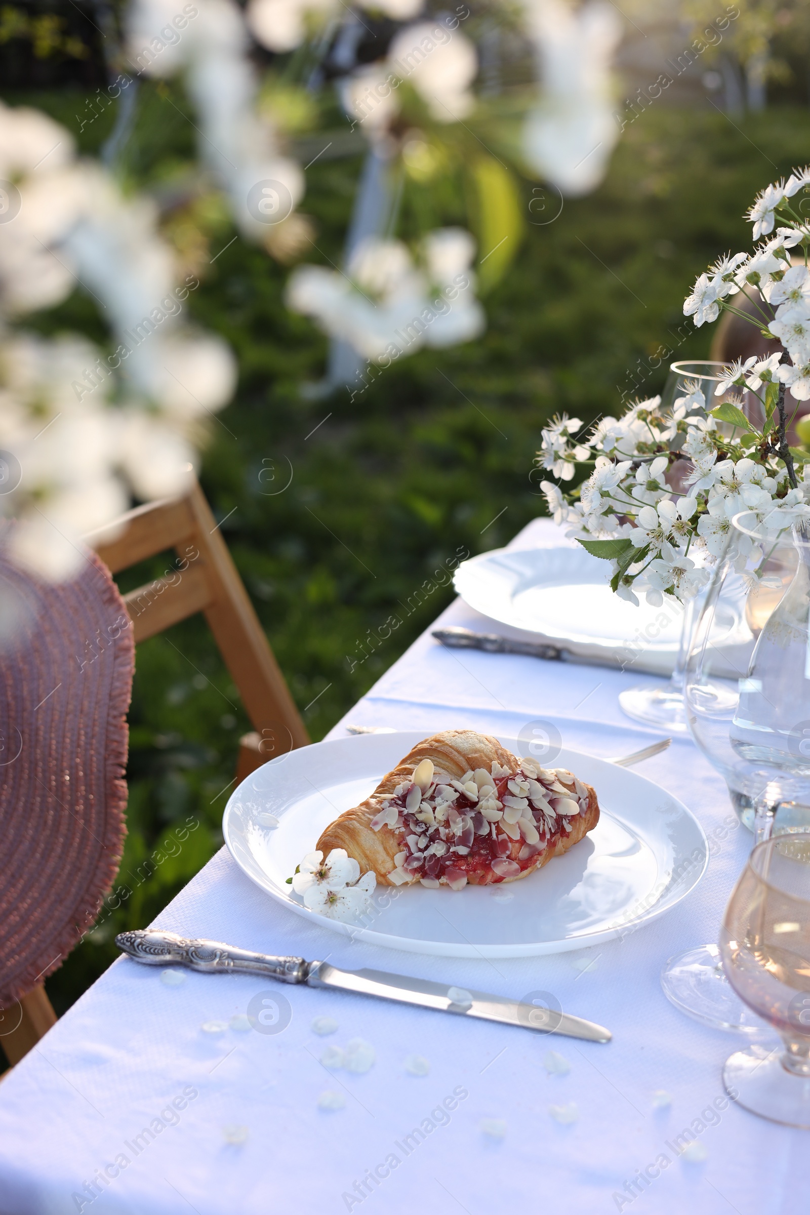 Photo of Stylish table setting with beautiful spring flowers in garden