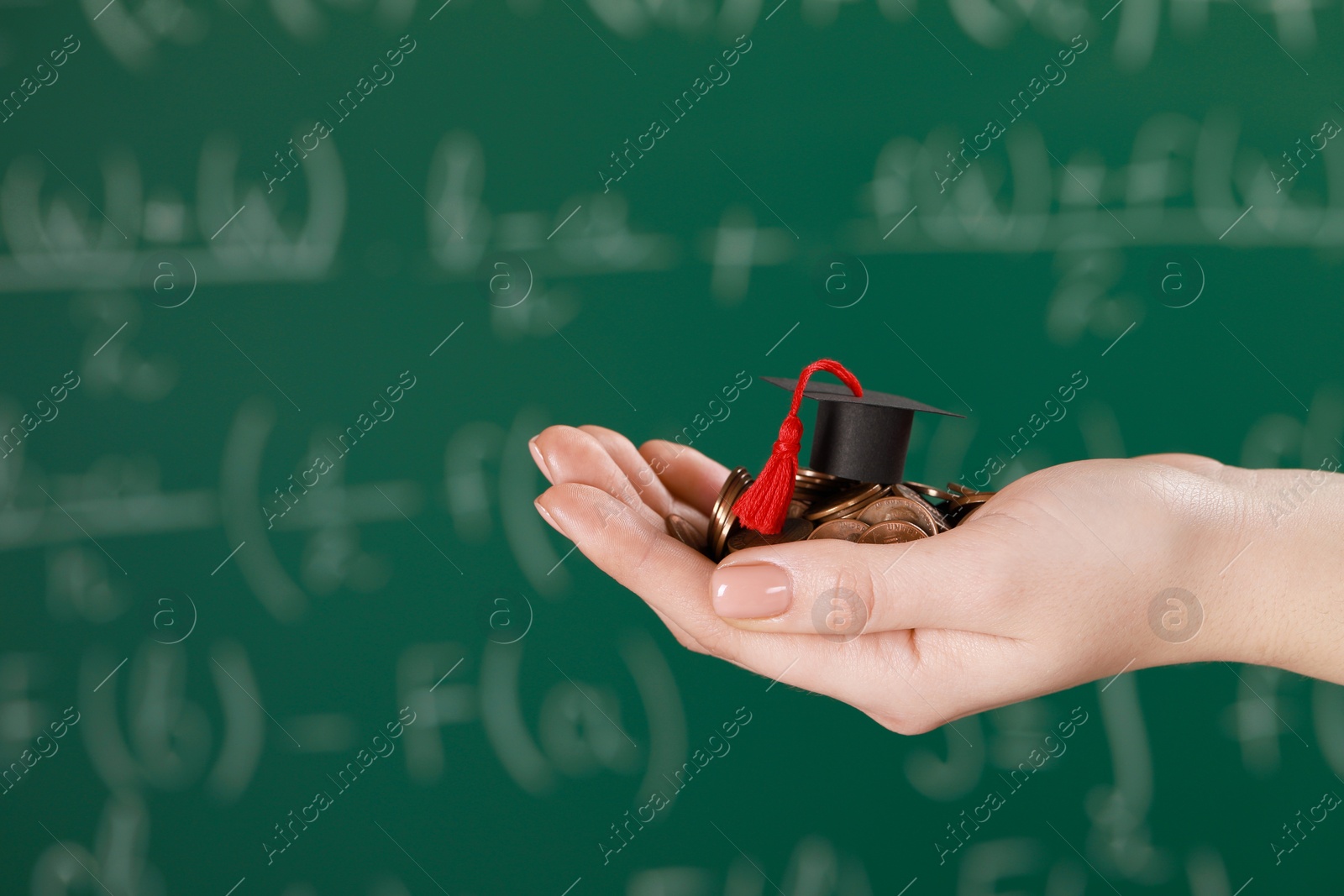 Photo of Woman holding coins and graduation cap against greenboard, closeup with space for text. Scholarship concept