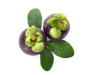 Photo of Delicious ripe mangosteens and green leaves on white background, top view
