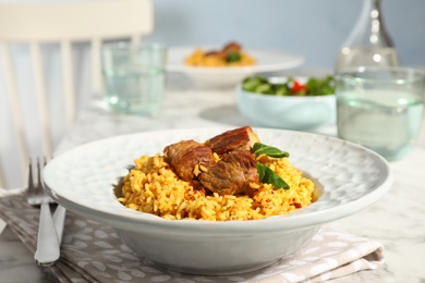 Photo of Plate with delicious rice pilaf served on table