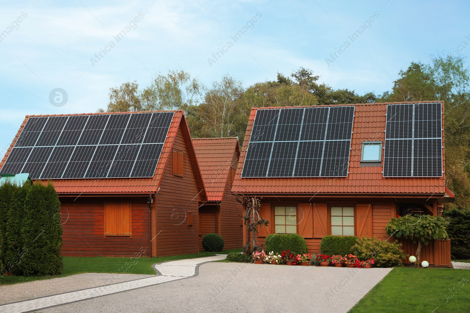 Photo of Beautiful houses with solar panels outdoors. Real estate for rent