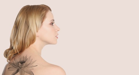 Image of Young woman with beautiful flower tattoo on light background, space for text. Banner design