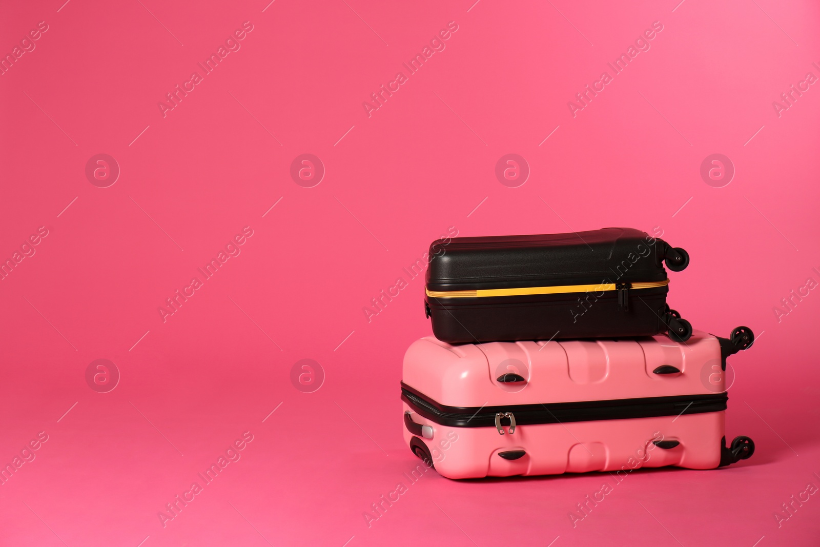 Photo of Stylish suitcases on color background. Space for text