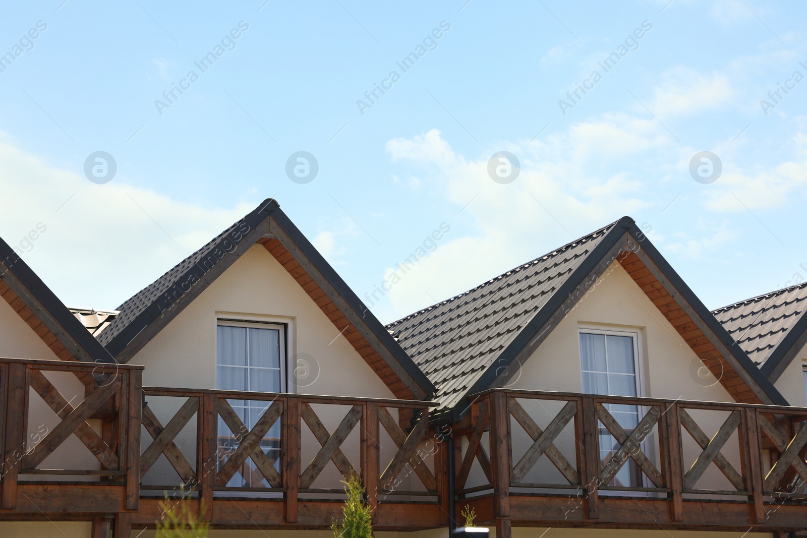 Photo of Exterior of beautiful houses with balconies against blue sky