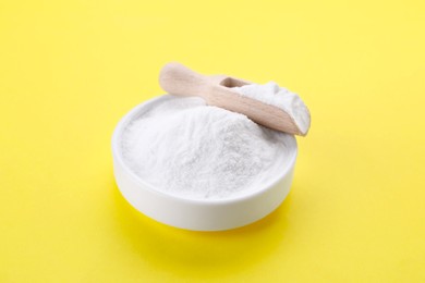 Photo of Bowl of sweet powdered fructose on yellow background