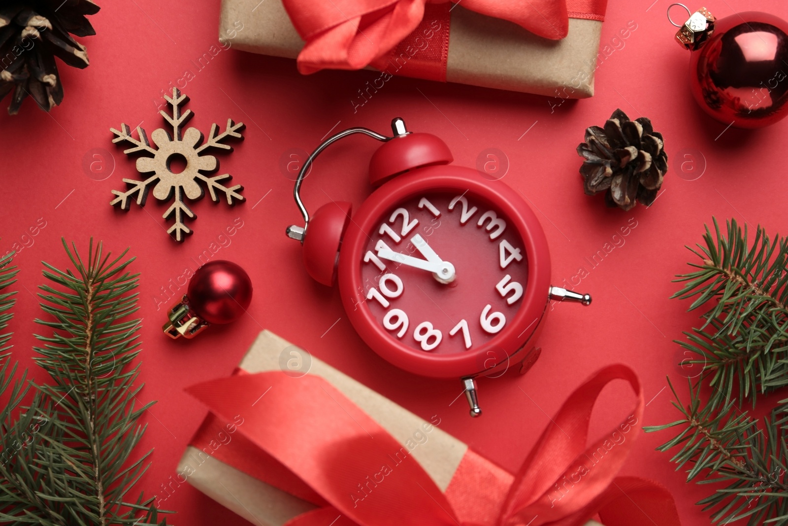 Photo of Flat lay composition with alarm clock and gifts on red background. Boxing day