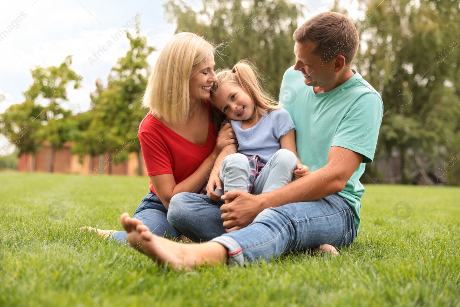 Photo of Happy family spending time together in park on sunny summer day