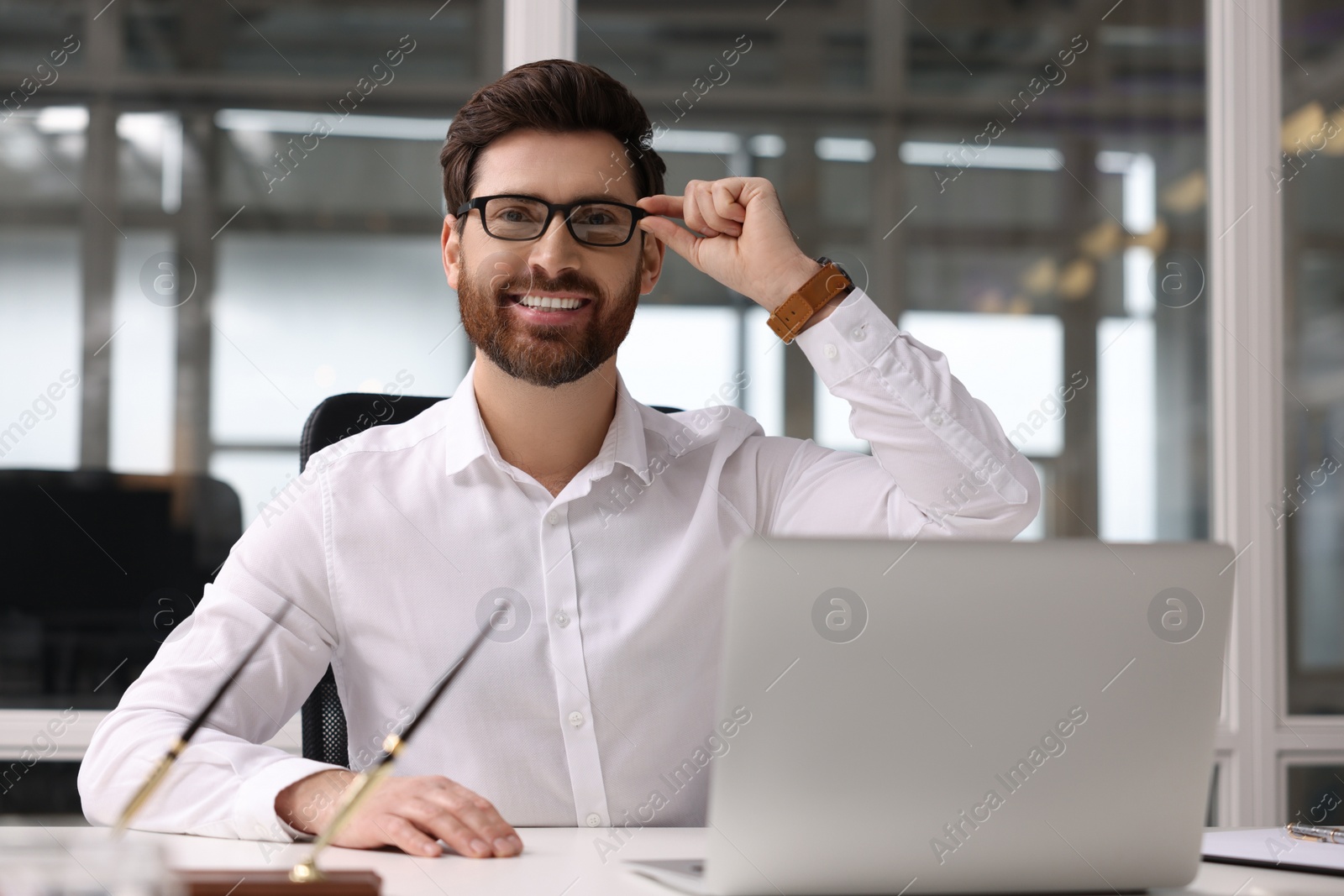 Photo of Portrait of smiling man in office. Lawyer, businessman, accountant or manager