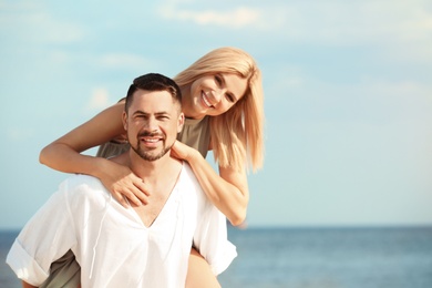 Happy romantic couple on beach, space for text