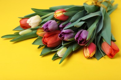 Photo of Bunch of beautiful tulips on yellow background
