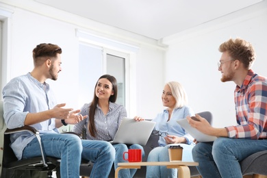 Photo of Business people discussing work matters in office. Professional communication