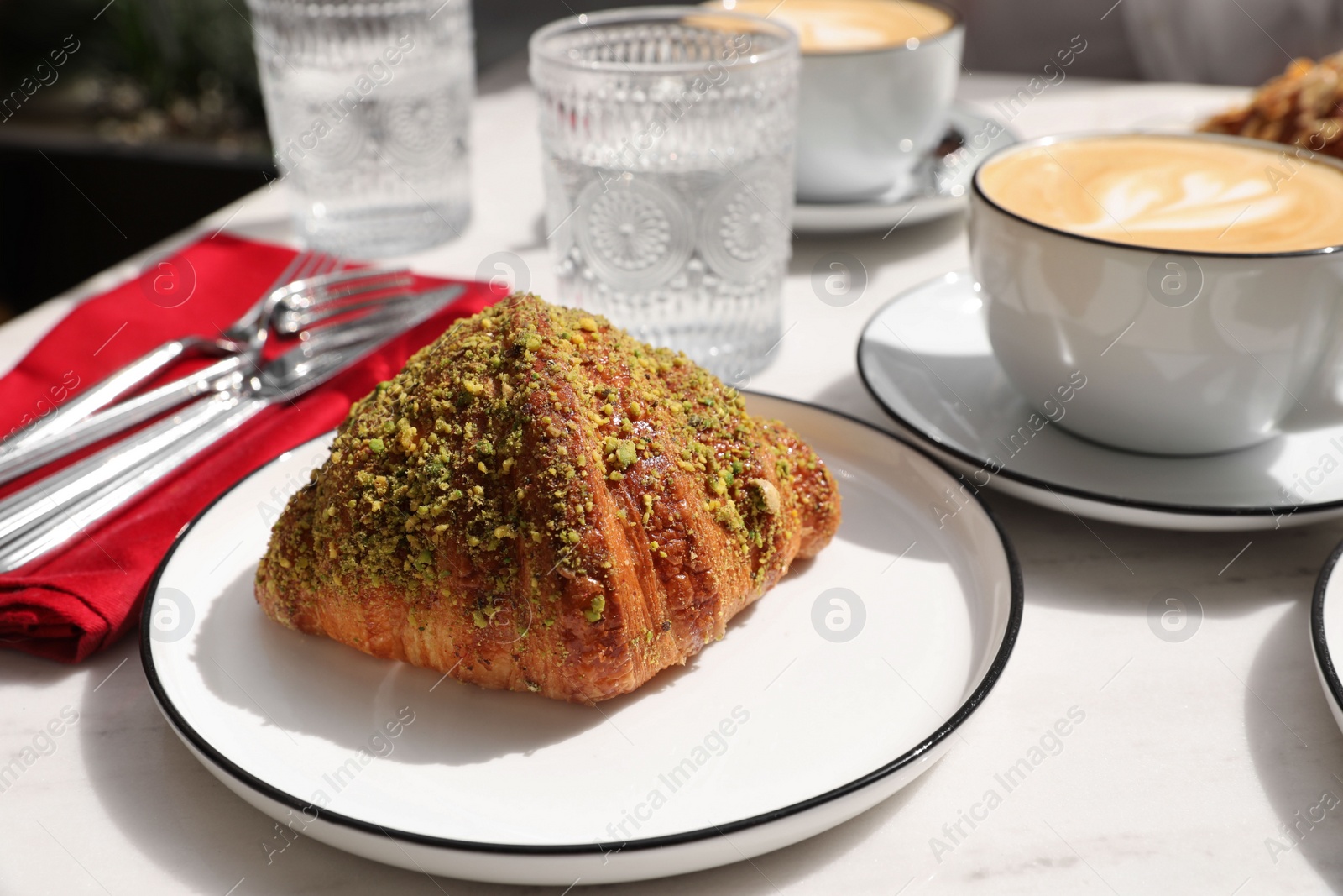 Photo of Delicious croissant and coffee on white marble table