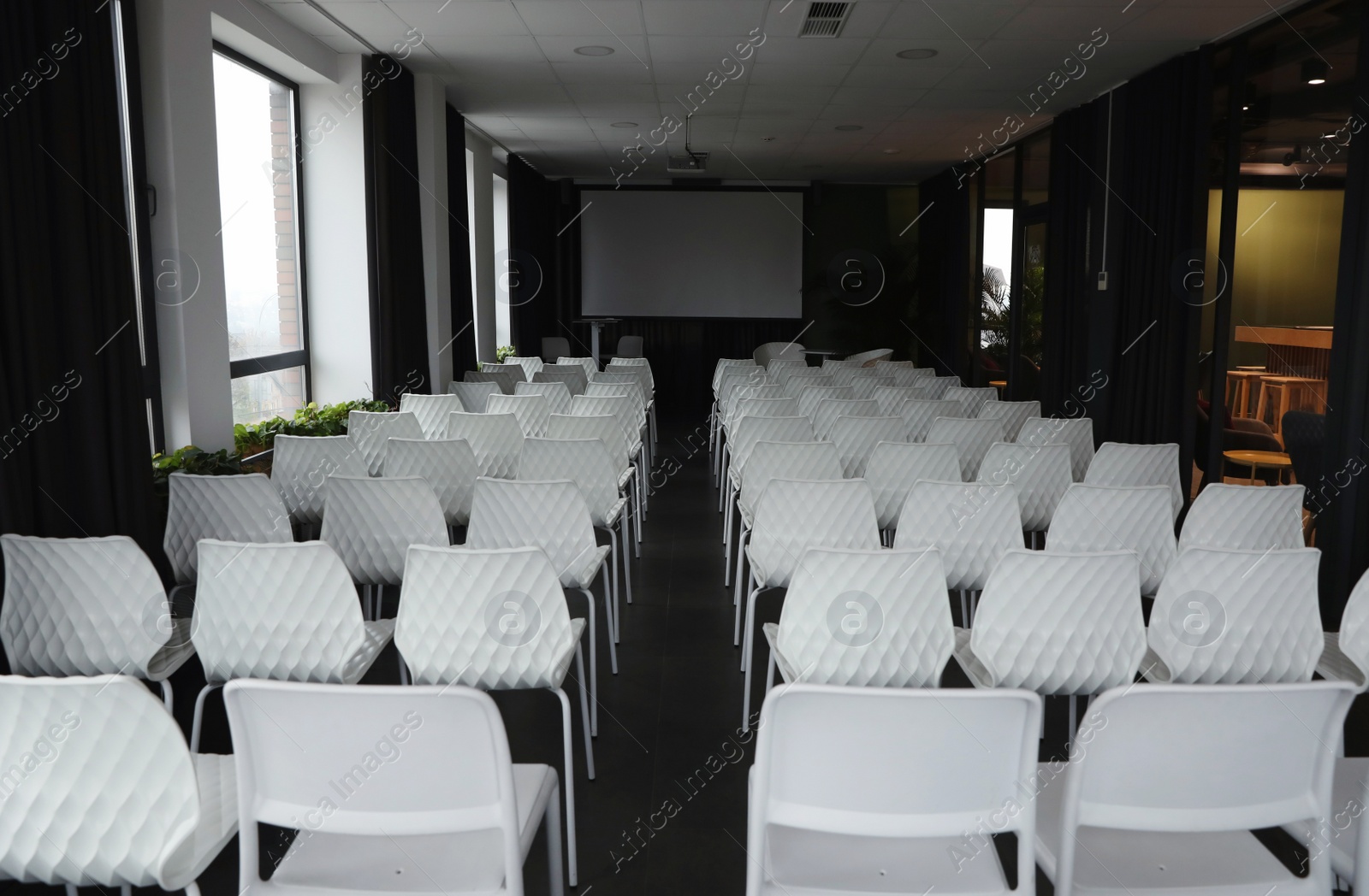 Photo of Empty conference hall with video projector and screen