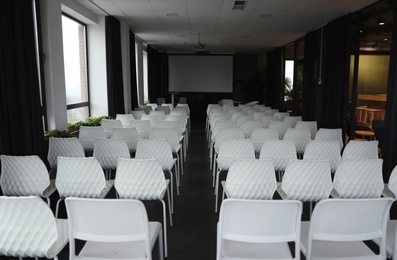 Photo of Empty conference hall with video projector and screen
