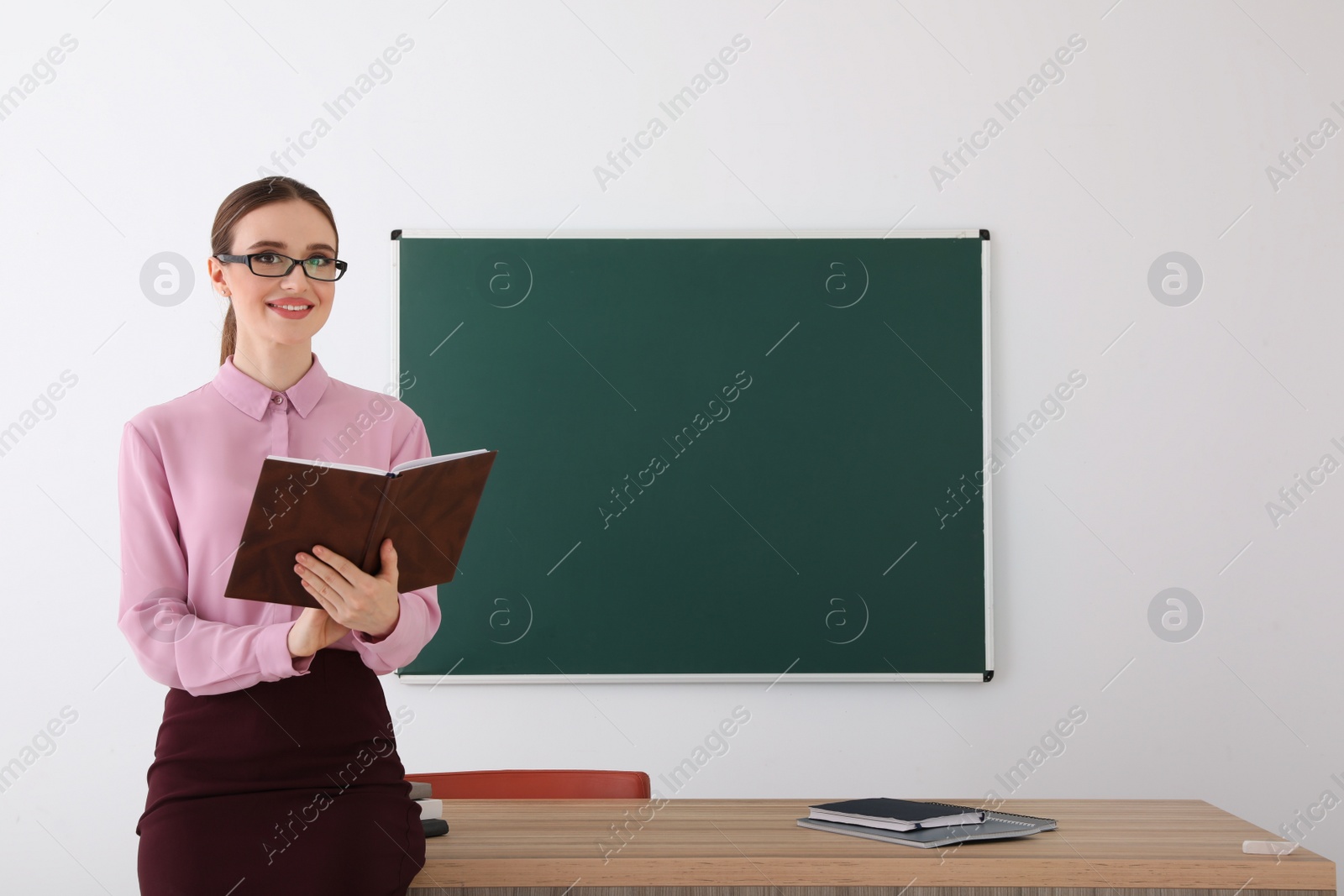 Photo of Portrait of young female teacher in classroom