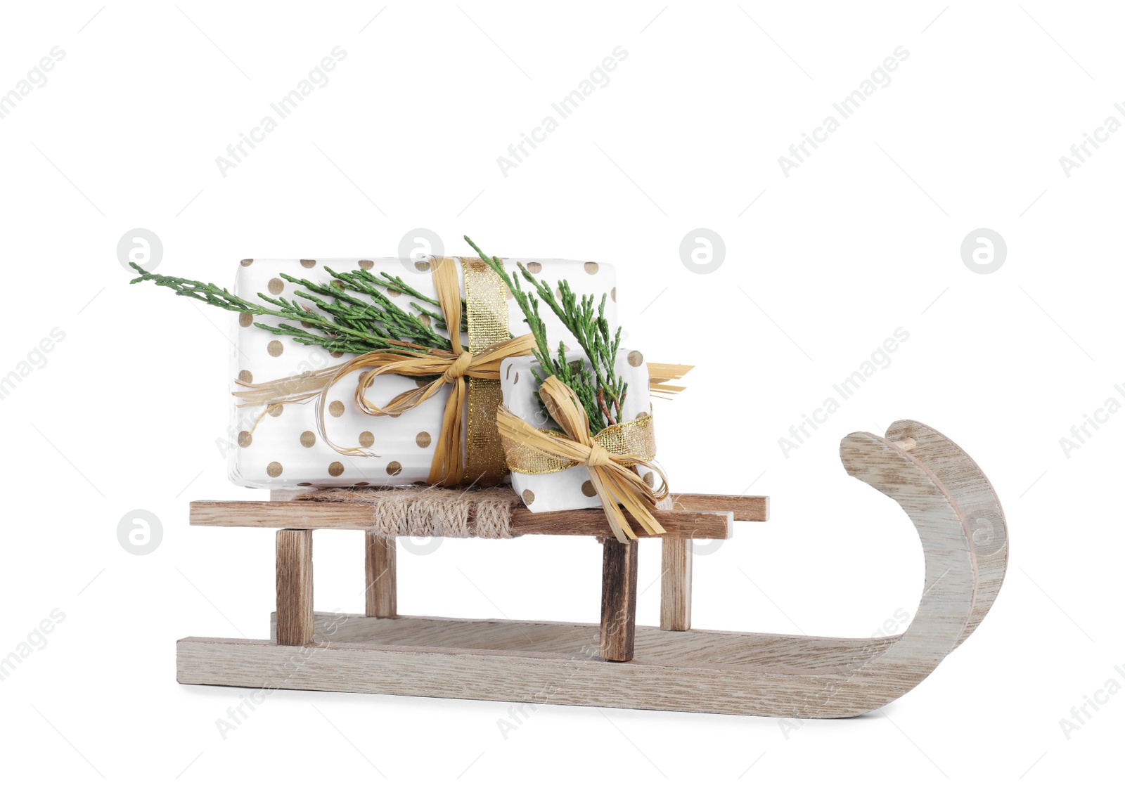 Photo of Wooden sleigh with gift boxes isolated on white. Christmas holiday decor