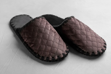 Photo of Pair of soft slippers on light grey background