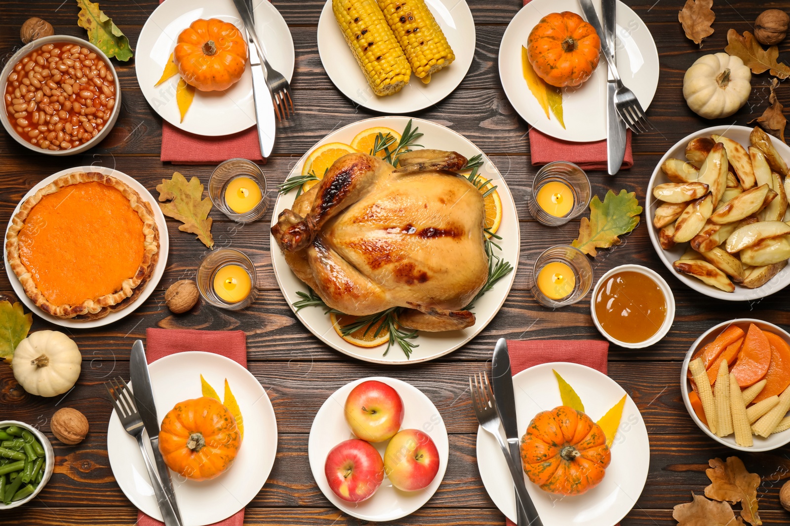 Photo of Traditional Thanksgiving day feast with delicious cooked turkey and other seasonal dishes served on wooden table, flat lay