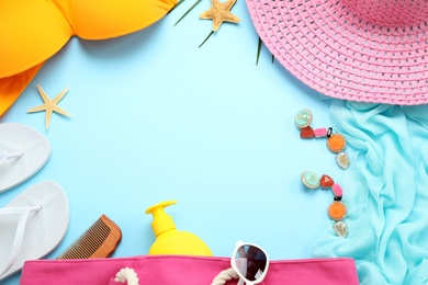 Photo of Flat lay composition with beach accessories on light blue background, space for text