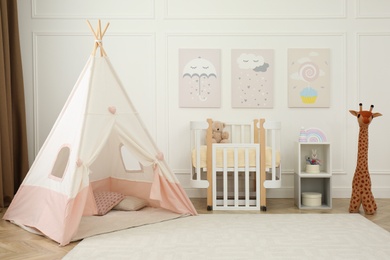 Cute baby room interior with crib and play tent