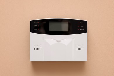 Photo of Home security alarm system on beige wall