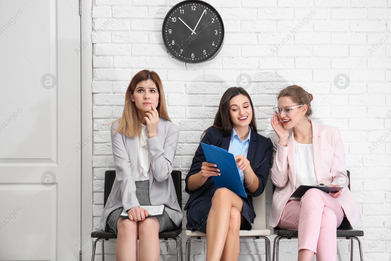 Photo of Young women waiting for job interview, indoors