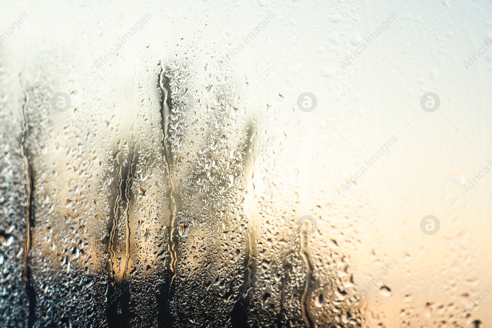 Photo of Rain drops on window glass as background, closeup