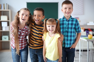 Photo of Cute little children in classroom. Elementary school